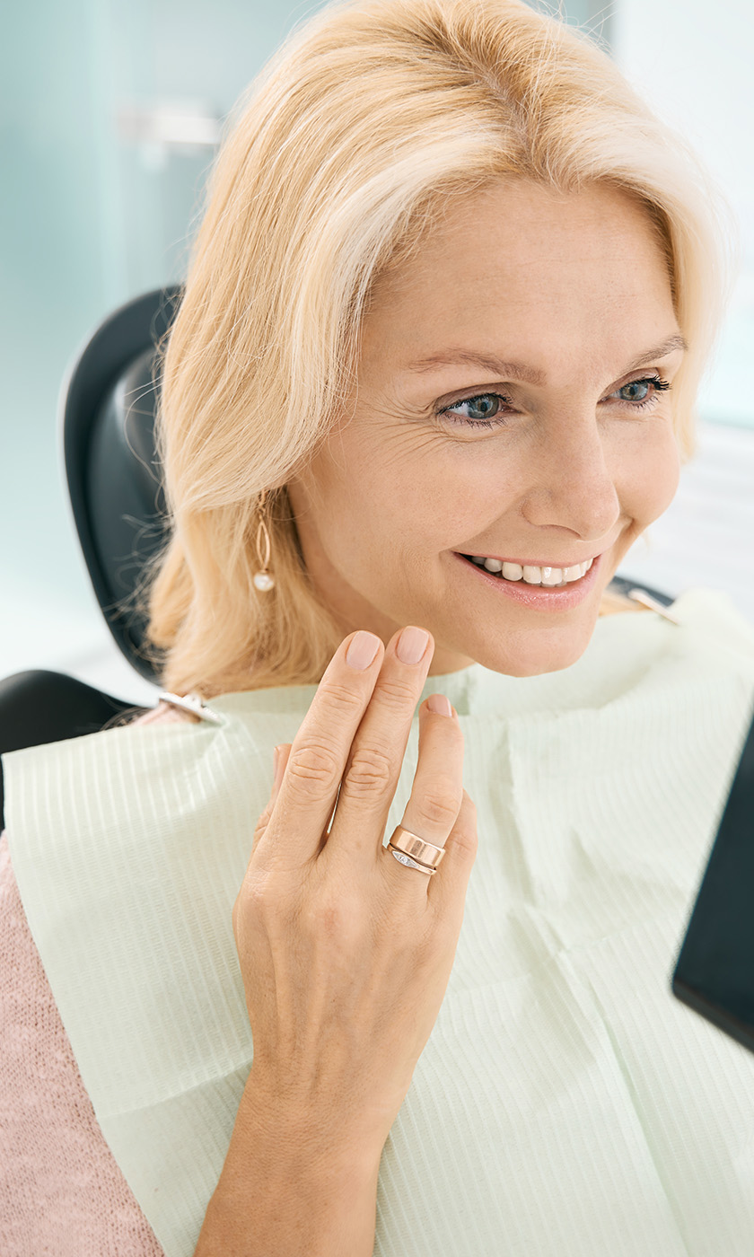 The image shows a modern dental or medical office interior with a dental chair, equipment, and a clean, professional environment.